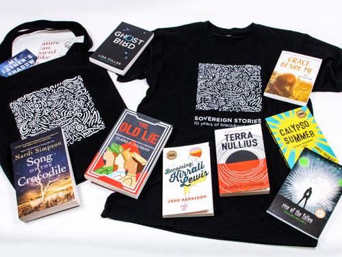 Novels, t-shirt and tote bag laid flat on a blank background.