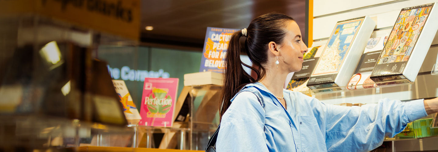 Woman browsing greeting cards in the Library Shop.